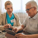 Woman showing guy an ipad with health info